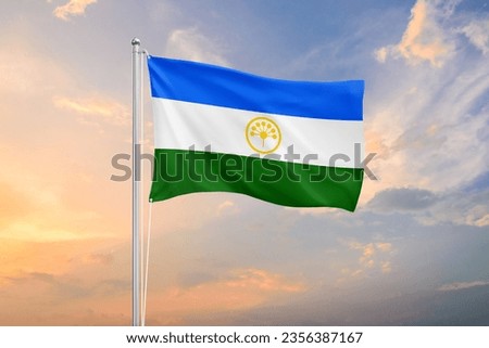 Bashkortostan flag waving on sundown sky