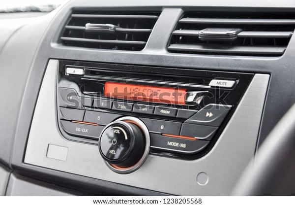 Basic car radio dashboard panel displaying\
welcome under air conditioner air\
fin