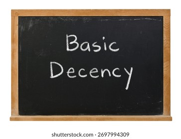 Basic Decency handwritten in white chalk on a black chalkboard isolated in a wooden frame