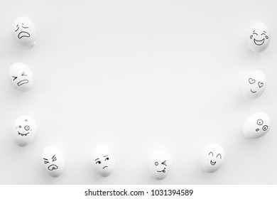 Basic emotions concept. Faces drawn on eggs. Happy, smile, sad, angry, in love. White background top view copy space
