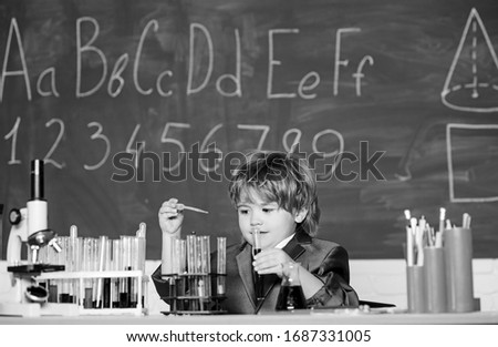 Basic knowledge primary school education. Educational experiment. Boy microscope and test tubes school classroom. Knowledge concept. Fascinating subject. Knowledge day. Kid study biology chemistry.