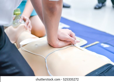 Basic Life Support Of Demonstrating Chest Compressions On CPR Doll
