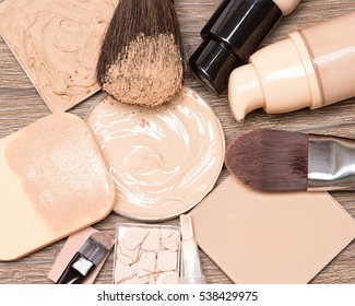 Basic make up products for flawless complexion: foundation, concealer, powder with cosmetic sponge and professional makeup brushes. Selective focus