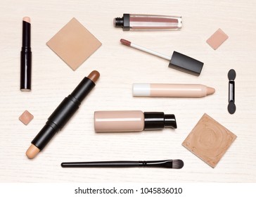 Basic Makeup Products: Primer, Concealer, Liquid Foundation, Cosmetic Face Powder On Light Wood Table, Flat Lay