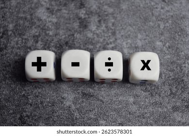 Basic mathematical operation symbols. Plus, minus, multiply and divide symbols on wooden cubes or dice. Basic calculate for business concept