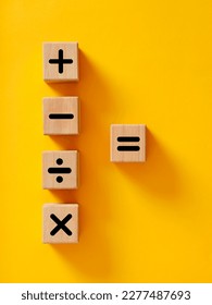 Basic mathematical operations symbols. Plus, minus, multiply, divide and equal symbols on wooden cubes. Mathematic or math education and basic calculations for business concept.