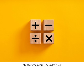 Basic mathematical operations symbols. Plus, minus, multiply and divide symbols on wooden cubes on yellow background. Mathematic or math education and basic calculations for business concept. - Shutterstock ID 2296192123