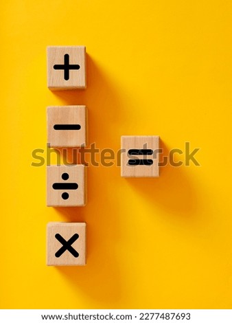 Basic mathematical operations symbols. Plus, minus, multiply, divide and equal symbols on wooden cubes. Mathematic or math education and basic calculations for business concept.