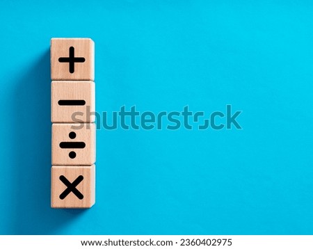 Basic mathematical operations symbols. Plus, minus, multiply and divide symbols on wooden cubes. Mathematic or math education and basic calculations for business concept.