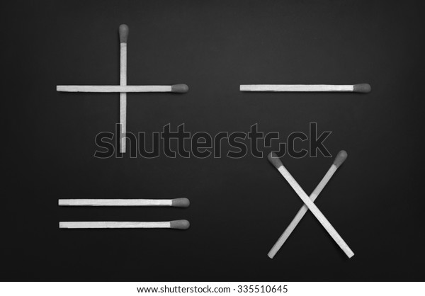 Basic mathematical symbols - plus,\
minus, multiplication & equal - on black\
chalkboard