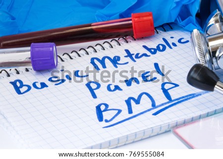 Basic metabolic panel (BMP) biochemical blood test concept photo. Note with text basic metabolic panel is next to lab test tubes with blood, gloves and stethoscope in  laboratory or in doctor office
