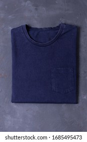 Basic Navy Tshirt On Grey Concrete Background. Mock Up For Branding T-shirt With Pocket. 