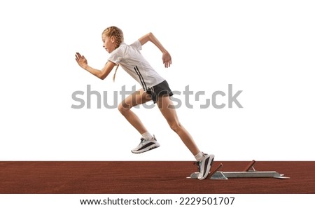Basic running technique. Young athlete, beginner female track runner bursting off starting block isolated on white background. Concept of sport, workout, skills and achievements. Little girl training