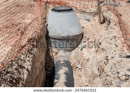 Basic sanitation work in the middle of a residential area with a small fence as protection