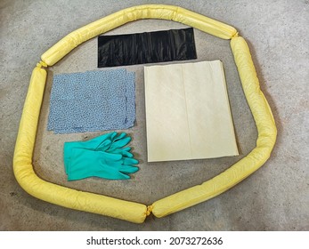 Basic spill kit comprises of rubber gloves, bunds, absorbent materials and pads, as well as black trash bags.  - Shutterstock ID 2073272636