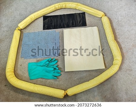 Basic spill kit comprises of rubber gloves, bunds, absorbent materials and pads, as well as black trash bags. 