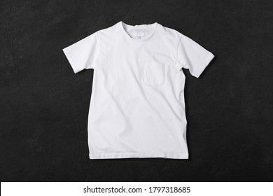 Basic White Tshirt On Concrete Background. Mock Up For Branding T-shirt With Pocket. 
