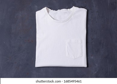 Basic white Tshirt on grey concrete background. Mock up for branding t-shirt with pocket.  - Shutterstock ID 1685495461