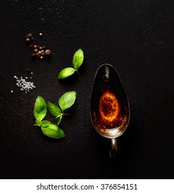 Basil Oil, Salt And Pepper On A Black Background