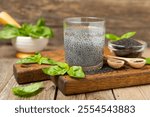 Basil seeds on textured wooden background. Close-up. Superfood. Ocimum basilicum. Organic basil seeds. selasih. Space for text. Copy space.