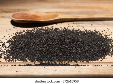 Basil Seeds On Wood Table.