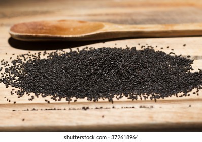 Basil Seeds On Wood Table.