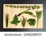 Basil, thyme, and rosemary on chopping block for nutrition, health and adding flavour to food. Green herbs, parsley and vegetables on kitchen cutting board for cooking, eating and vegan diet