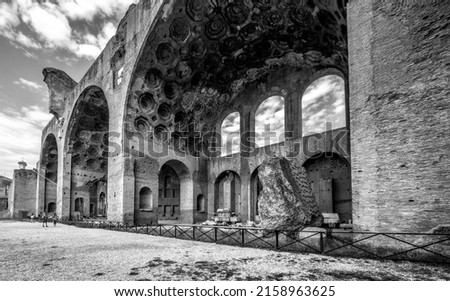 Basilica of Maxentius and Constantine in Roman Forum or Foro Romano, Rome, Italy. It is famous landmark of city. Black and white photo of majestic ruins of basilica, ancient temple in old Roma town.