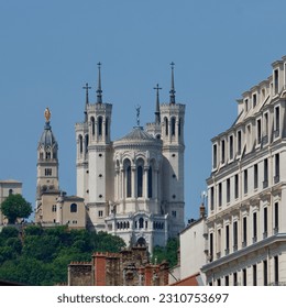 Basilica our lady of Fourvière in Lyon, France at the top of the fourvière hill with another building in the foreground. - Shutterstock ID 2310753697