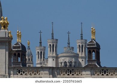 Basilica our lady of Fourvière at the top of the Fourviere hill in Lyon, France with hotel Dieu towers building in the foreground. - Shutterstock ID 2310761665