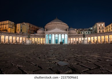 The Basilica of San Francesco di Paola in the Piazza del Plebiscito at night in Naples, Italy. The latin inscription atop the portico reads "DOMD FRANCISCO DE PAULA FERDINANDUS I EX VOTO A MDCCCXVI".