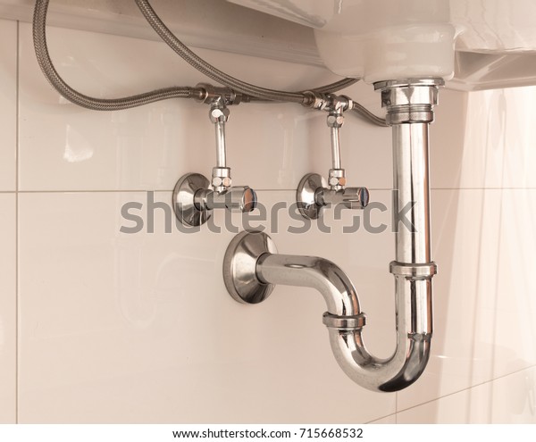 Basin siphon or\
sink drain in a bathroom,\
clean