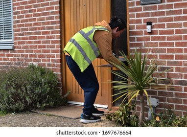 Basingstoke, Hampshire / UK - April 08 2020: An Amazon Driver Delivers A Parcel To A Customer's Home During The Coronavirus Lockdown. 