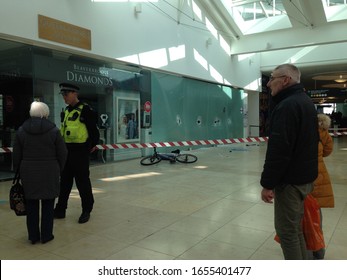 Basingstoke, UK- February 25, 2019: A Police Officer Talking To Potential Witnesses After A Smash And Grab Robbery At Beverbrook's Jewellery Shop In Festival Place, Basingstoke