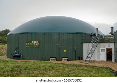 Basingstoke, UK - September 23, 2019: One of the large digesters which convert waste food into energy at the Herriard Bio Power plant on a rainy day in Hampshire.