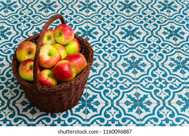 Basket Of Apple On Kitchen Tile Floor