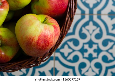 Basket Of Apple On Kitchen Tile Floor