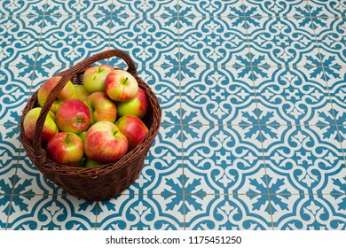 Basket Of Apple On Kitchen Tile Floor