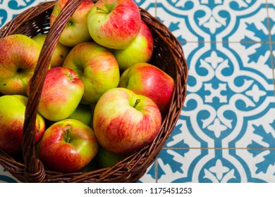 Basket Of Apple On Kitchen Tile Floor