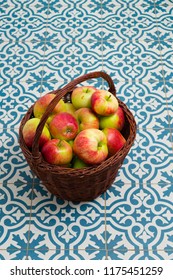 Basket Of Apple On Kitchen Tile Floor