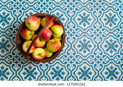 Basket Of Apple On Kitchen Tile Floor