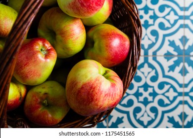 Basket Of Apple On Kitchen Tile Floor