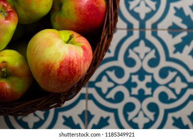 Basket Of Apple On Kitchen Tile Floor