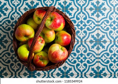 Basket Of Apple On Kitchen Tile Floor