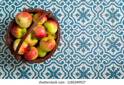 Basket Of Apple On Kitchen Tile Floor