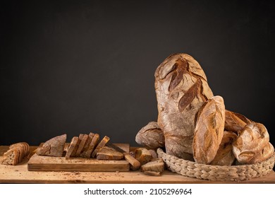 Basket of artisan breads and slices with copy space on blackboard - Powered by Shutterstock