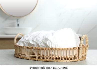 Basket With Baby Diapers On Counter In Bathroom