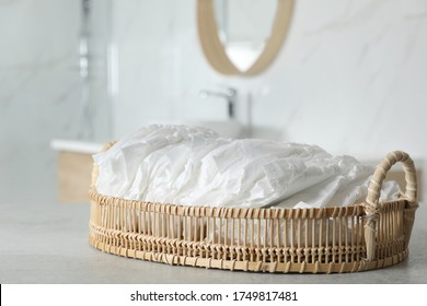 Basket With Baby Diapers On Counter In Bathroom