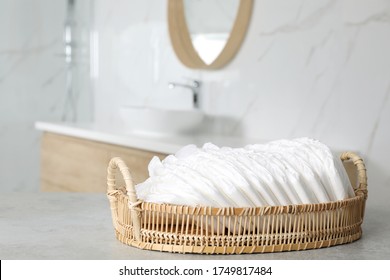 Basket With Baby Diapers On Counter In Bathroom