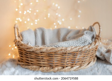 Basket For Baby With Knitted Blanket And Bokeh Background 